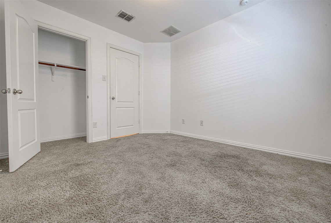 239 Pond View Pass Buda, TX 78610 - Photo 11 of 30 Unfurnished bedroom featuring carpet and a closet