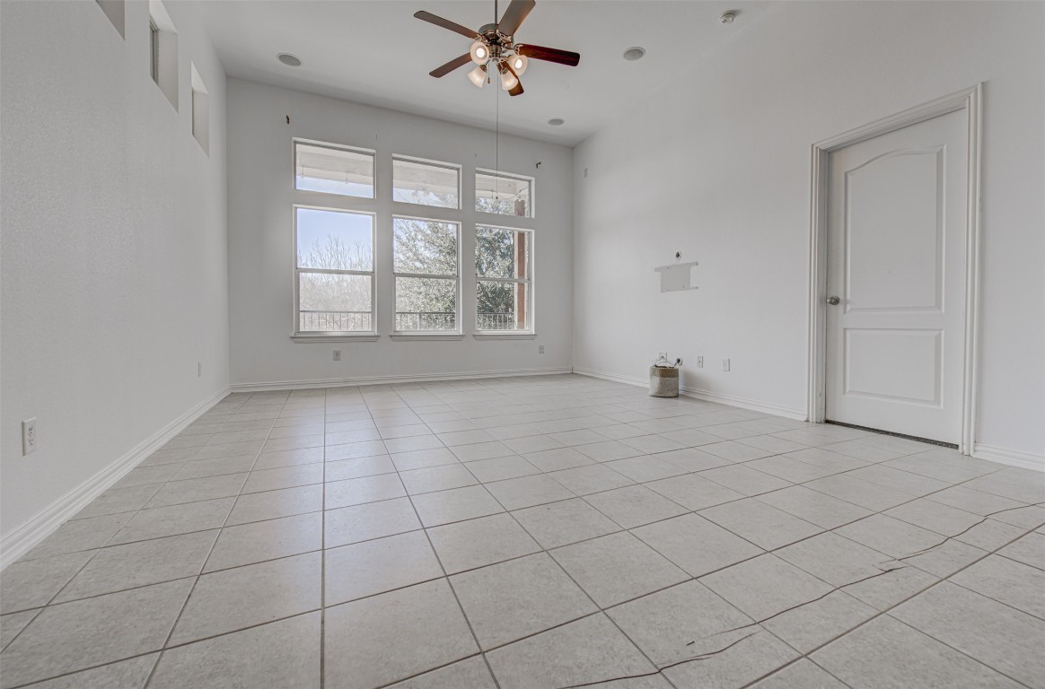 239 Pond View Pass Buda, TX 78610 - Photo 17 of 30 Unfurnished room featuring a ceiling fan and light tile patterned flooring