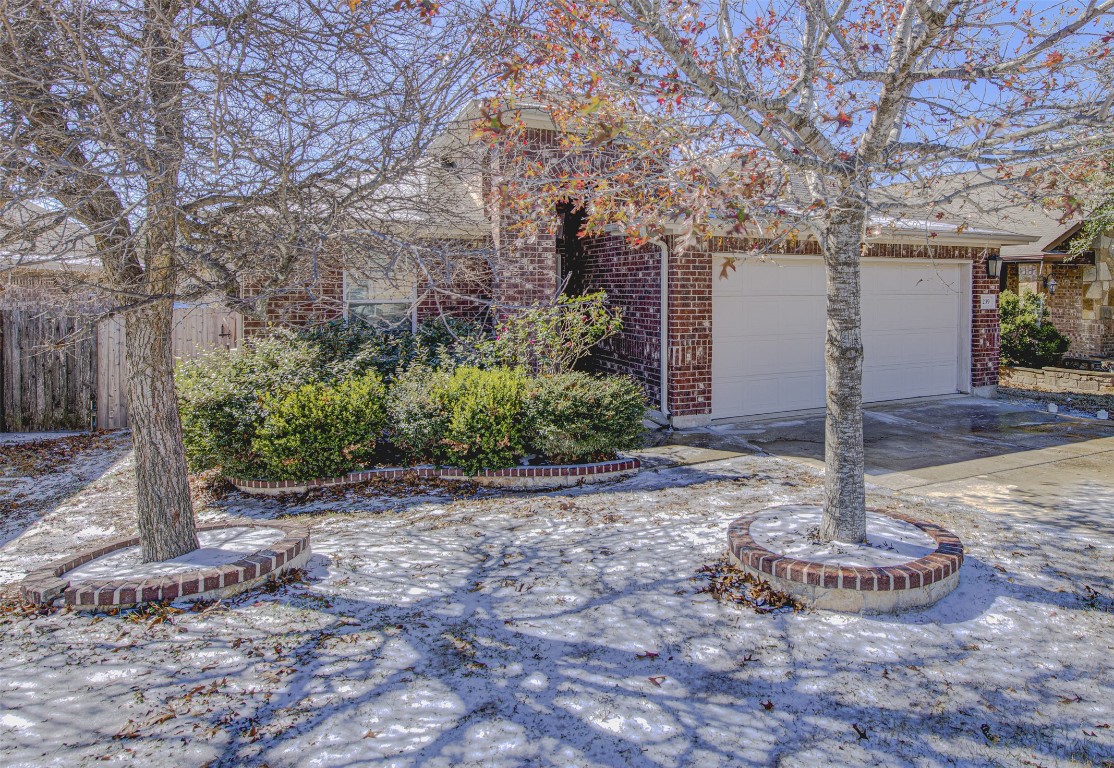 239 Pond View Pass Buda, TX 78610 - Photo 2 of 30 Obstructed view of property featuring brick siding and driveway