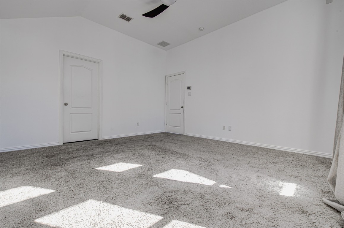 239 Pond View Pass Buda, TX 78610 - Photo 21 of 30 Empty room with carpet floors, lofted ceiling, and a ceiling fan