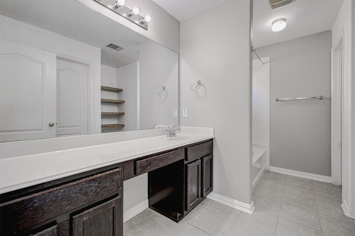 239 Pond View Pass Buda, TX 78610 - Photo 22 of 30 Bathroom featuring vanity, tub / shower combination, and light tile patterned floors
