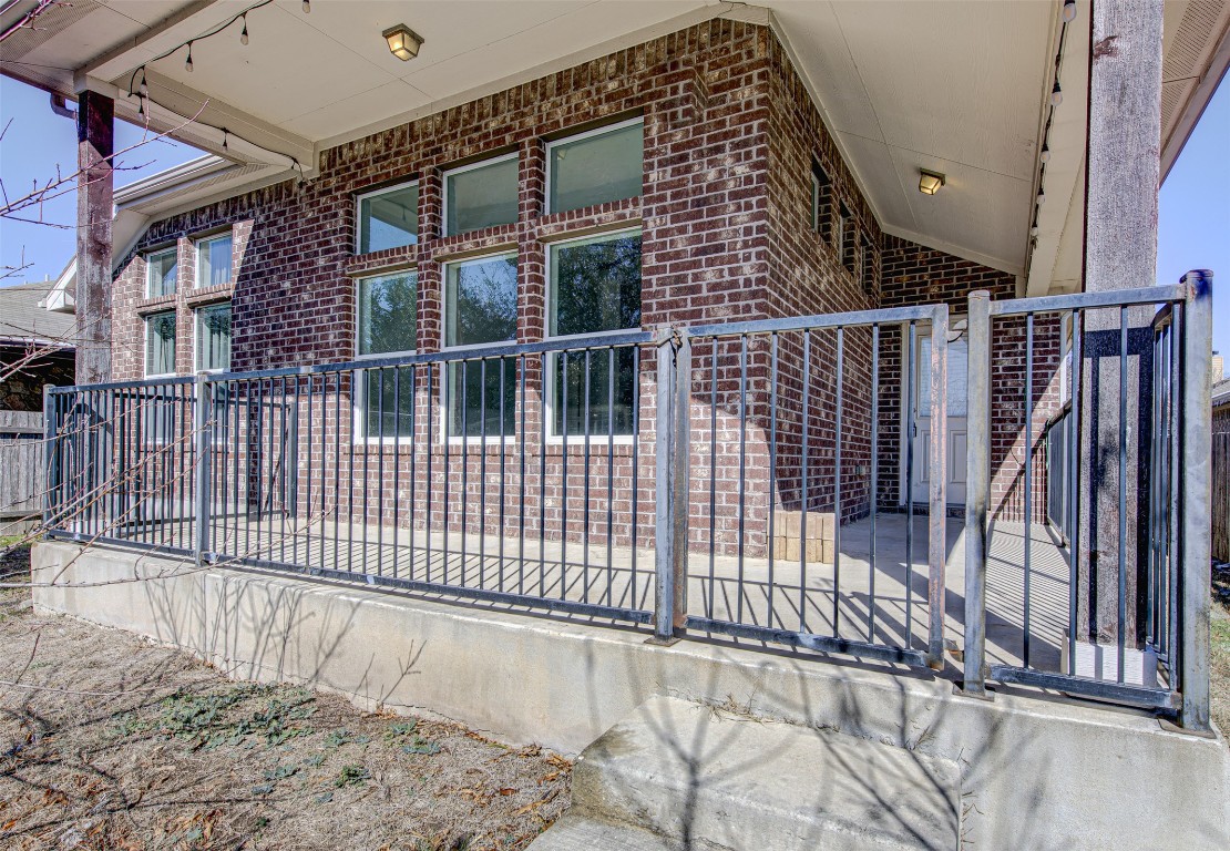 239 Pond View Pass Buda, TX 78610 - Photo 29 of 30 View of side of home with brick siding and a gate