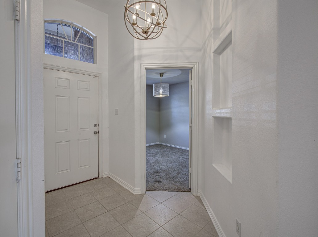239 Pond View Pass Buda, TX 78610 - Photo 7 of 30 Entrance foyer featuring a chandelier and light tile patterned flooring