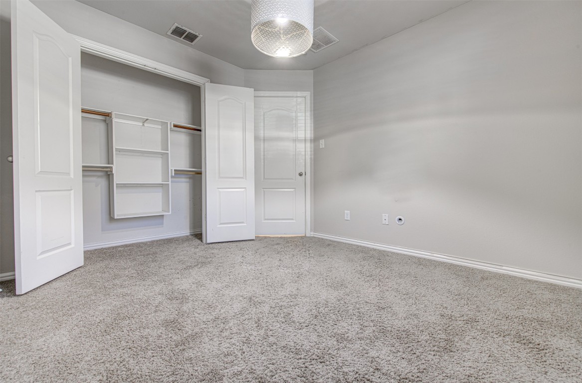 239 Pond View Pass Buda, TX 78610 - Photo 10 of 30 Unfurnished bedroom featuring light carpet and a closet