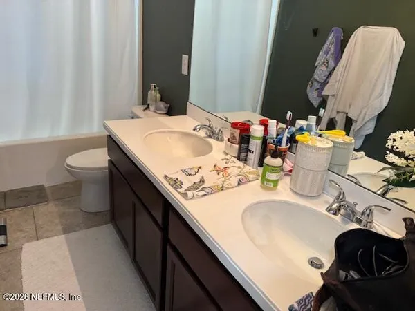 a bathroom with a sink mirror and toilet
