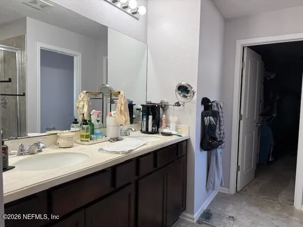 a bathroom with a sink double vanity and mirror