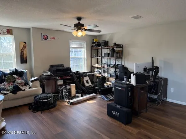 a living room with furniture and wooden floor
