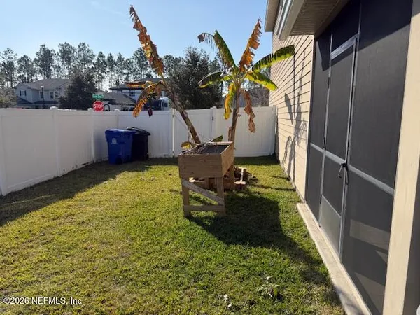 a view of a backyard with chairs