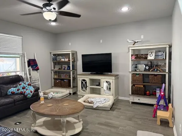 a living room with furniture and a flat screen tv