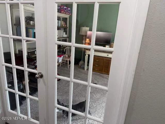 a utility room with dryer washer and a view of kitchen