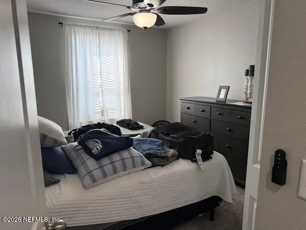 a bedroom with a bed and window