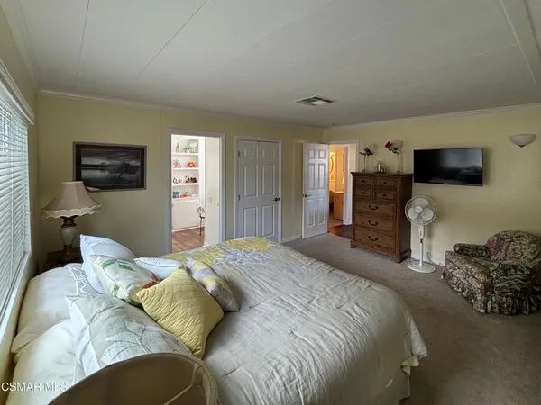 a bedroom with a bed and a television