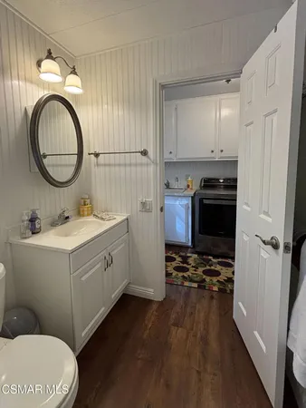 a bathroom with a sink a toilet and a mirror