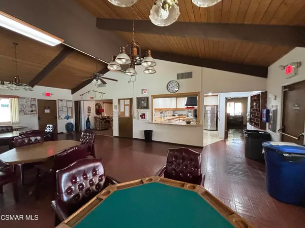 a kitchen with stainless steel appliances kitchen island granite countertop a stove and a refrigerator
