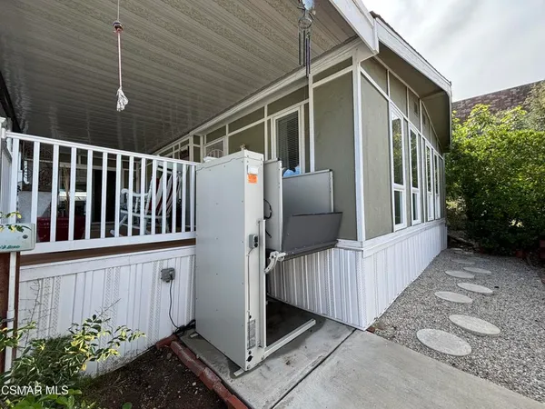 a view of porch with wooden fence and stairs