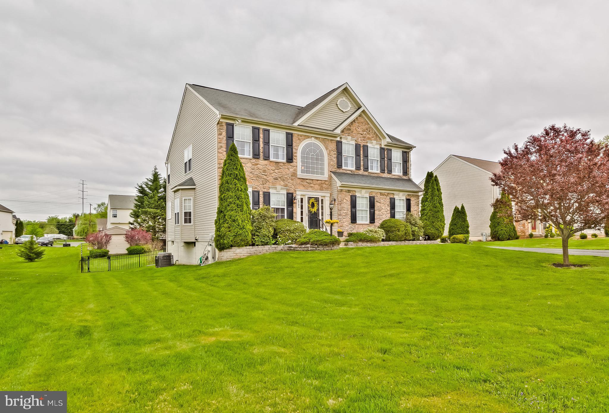 5704 New Forge Road White Marsh, MD 21162 - Photo 2 of 30 a front view of a house with a garden
