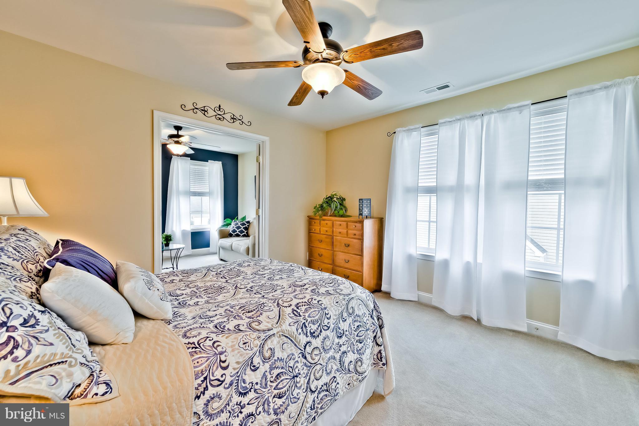 5704 New Forge Road White Marsh, MD 21162 - Photo 13 of 30 a bedroom with a large bed and a chandelier
