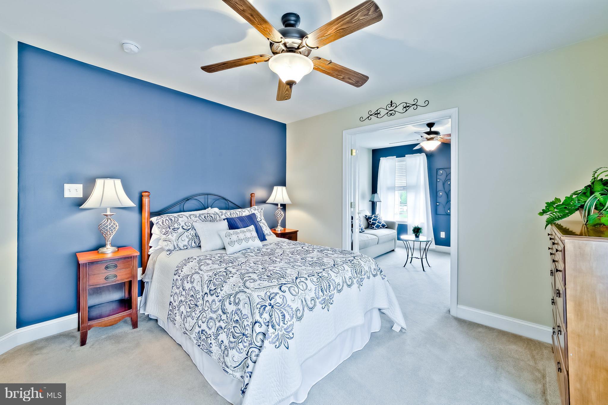 5704 New Forge Road White Marsh, MD 21162 - Photo 14 of 30 a bedroom with a bed and a chandelier