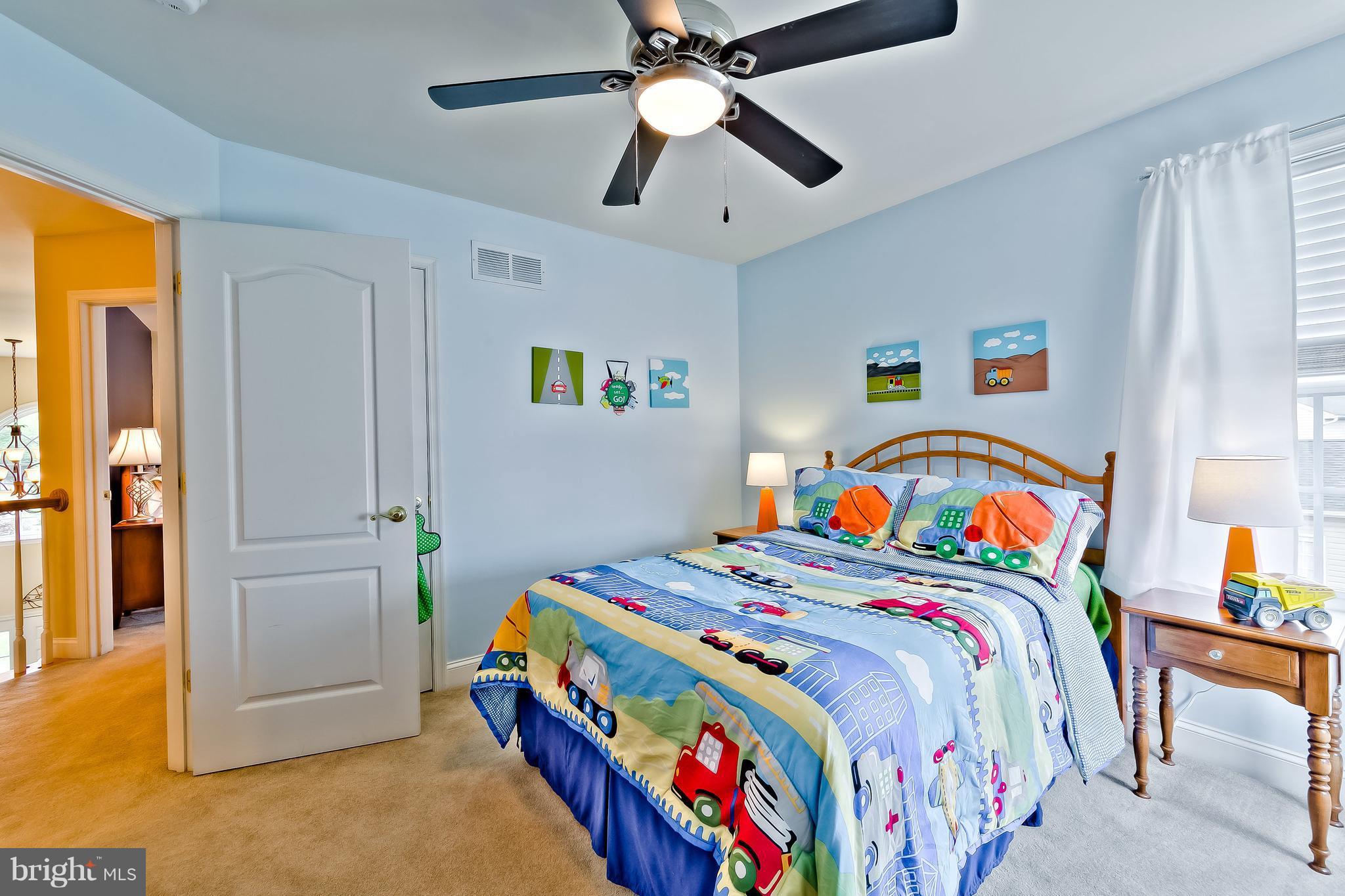 5704 New Forge Road White Marsh, MD 21162 - Photo 17 of 30 a bedroom with a bed and a chandelier