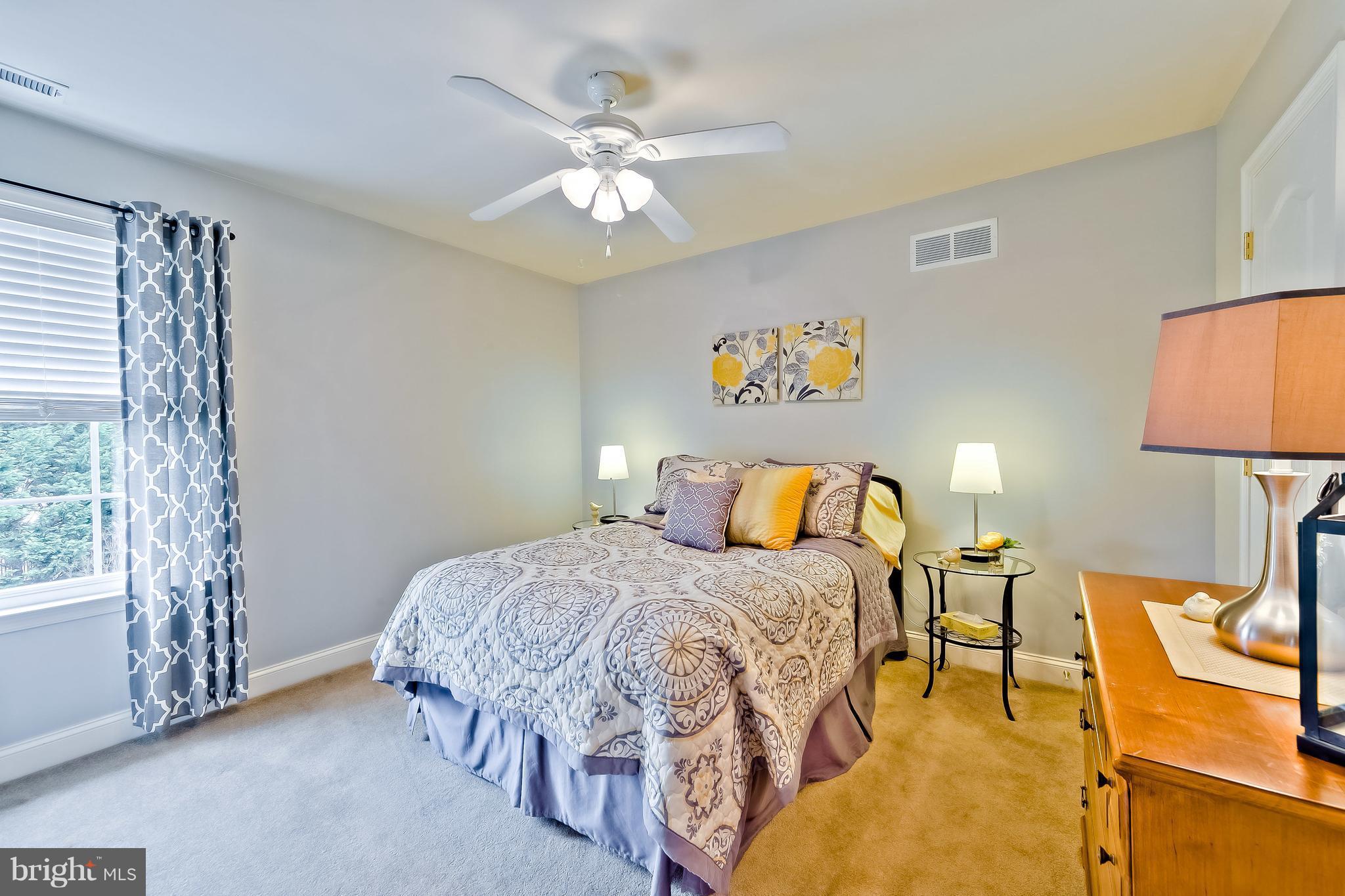 5704 New Forge Road White Marsh, MD 21162 - Photo 19 of 30 a bedroom with a bed and a chandelier