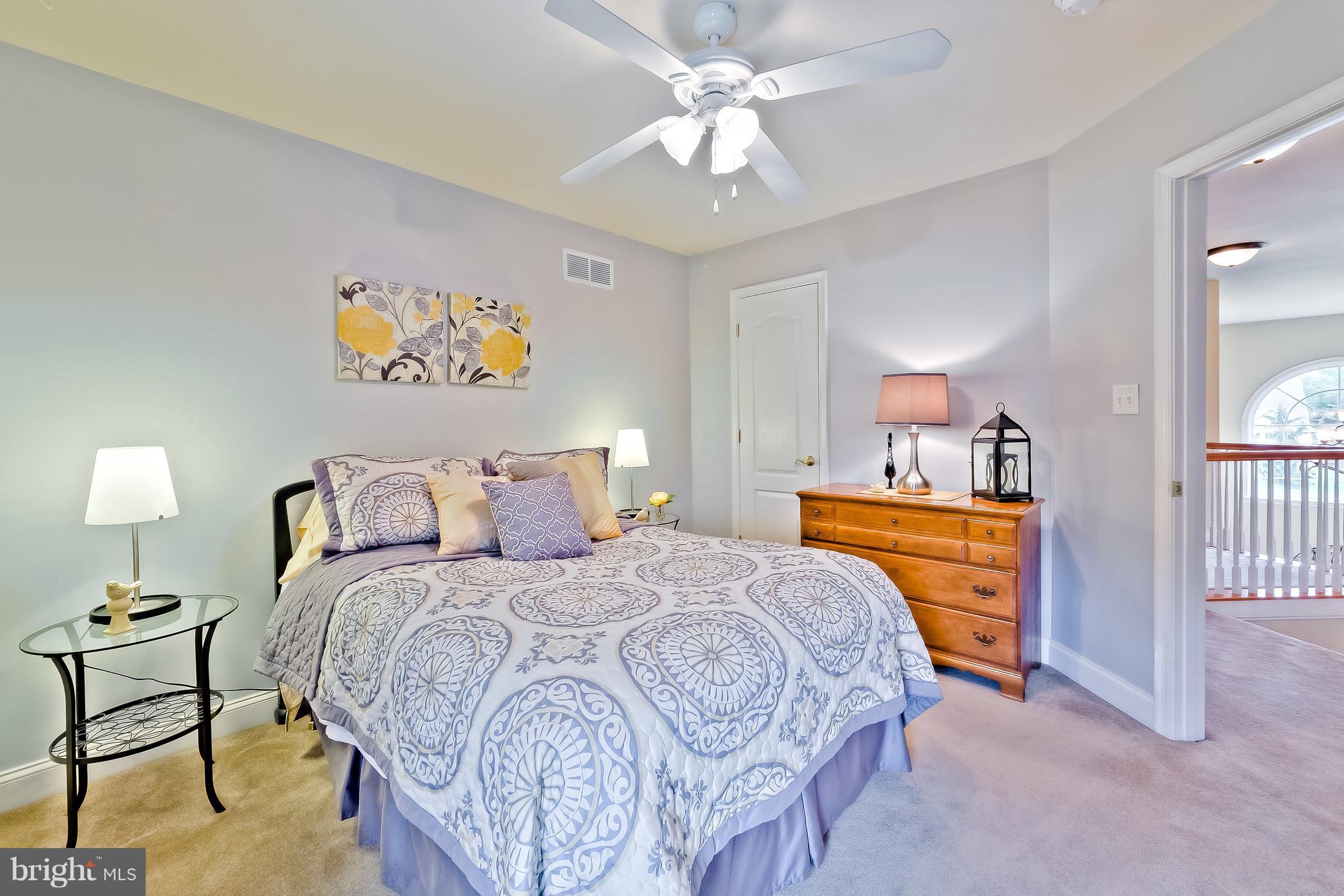 5704 New Forge Road White Marsh, MD 21162 - Photo 20 of 30 a bedroom with a bed and a chandelier