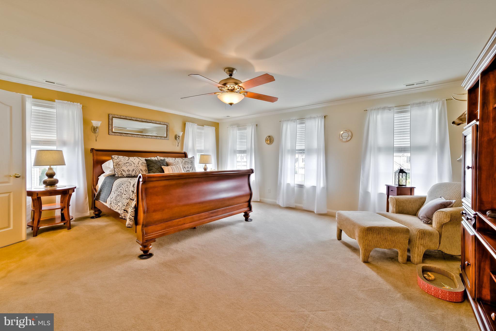 5704 New Forge Road White Marsh, MD 21162 - Photo 21 of 30 a bedroom with furniture and a chandelier