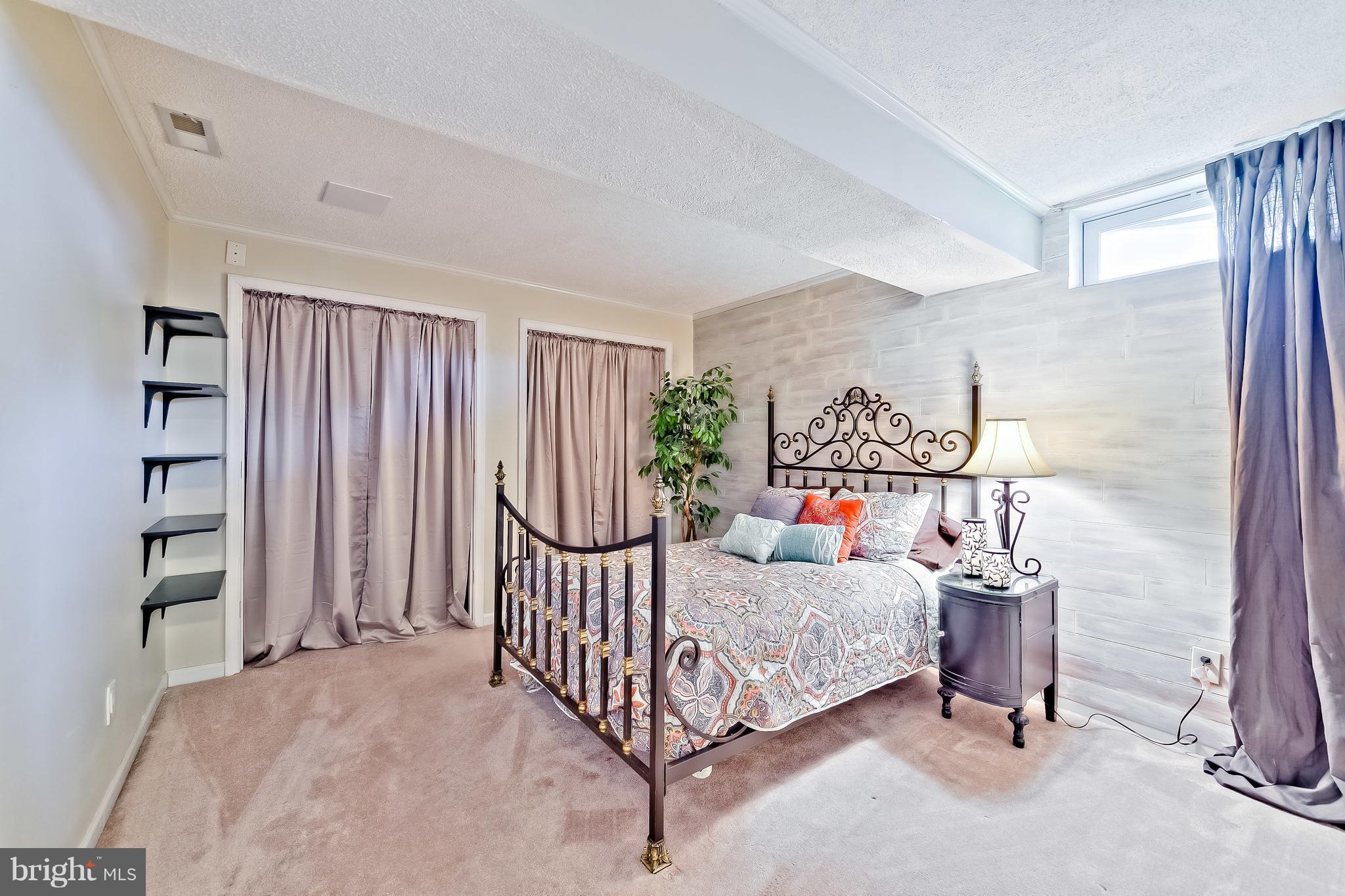 5704 New Forge Road White Marsh, MD 21162 - Photo 28 of 30 a bedroom with furniture and a chandelier