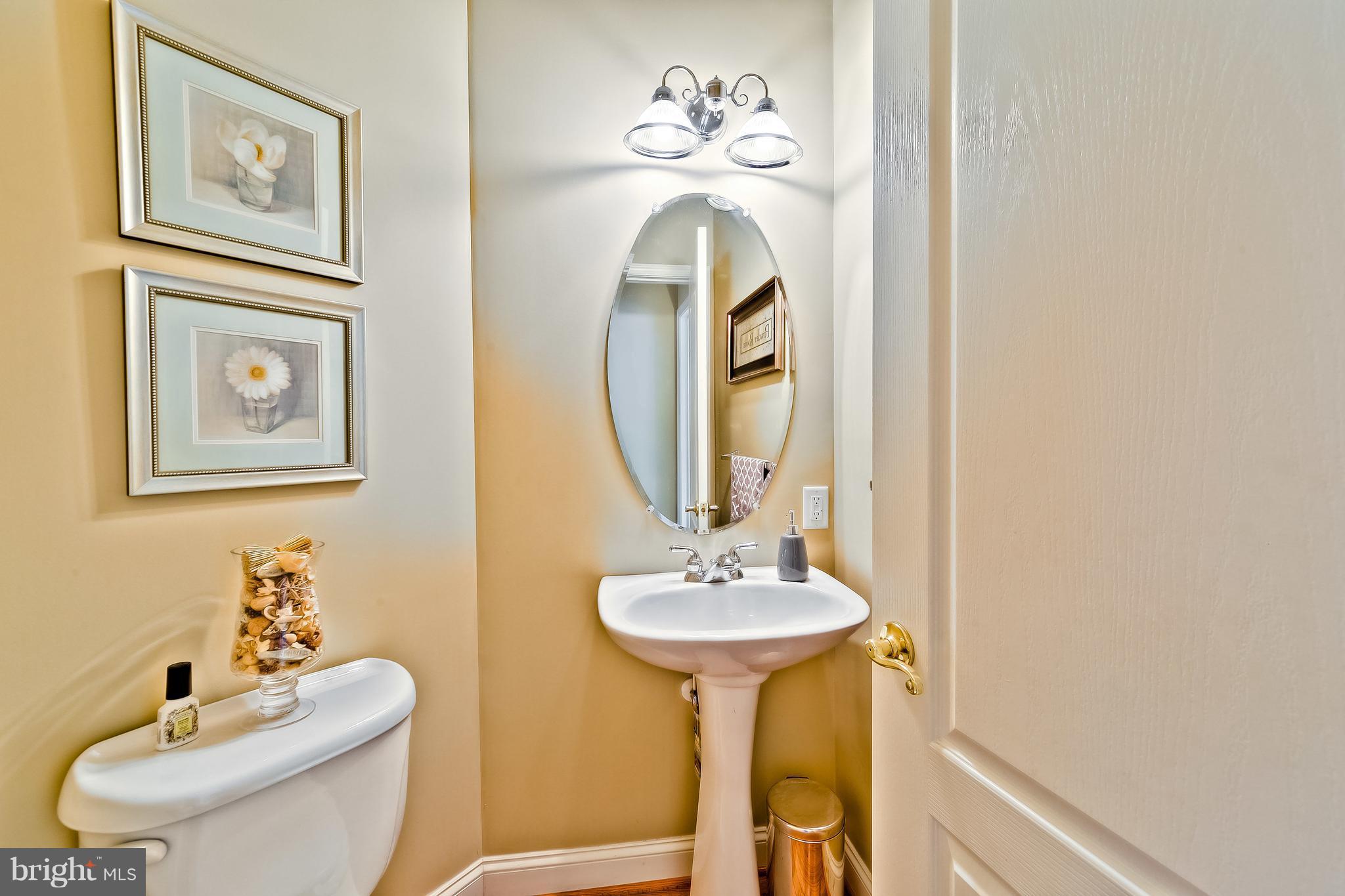 5704 New Forge Road White Marsh, MD 21162 - Photo 9 of 30 a bathroom with a toilet sink and mirror