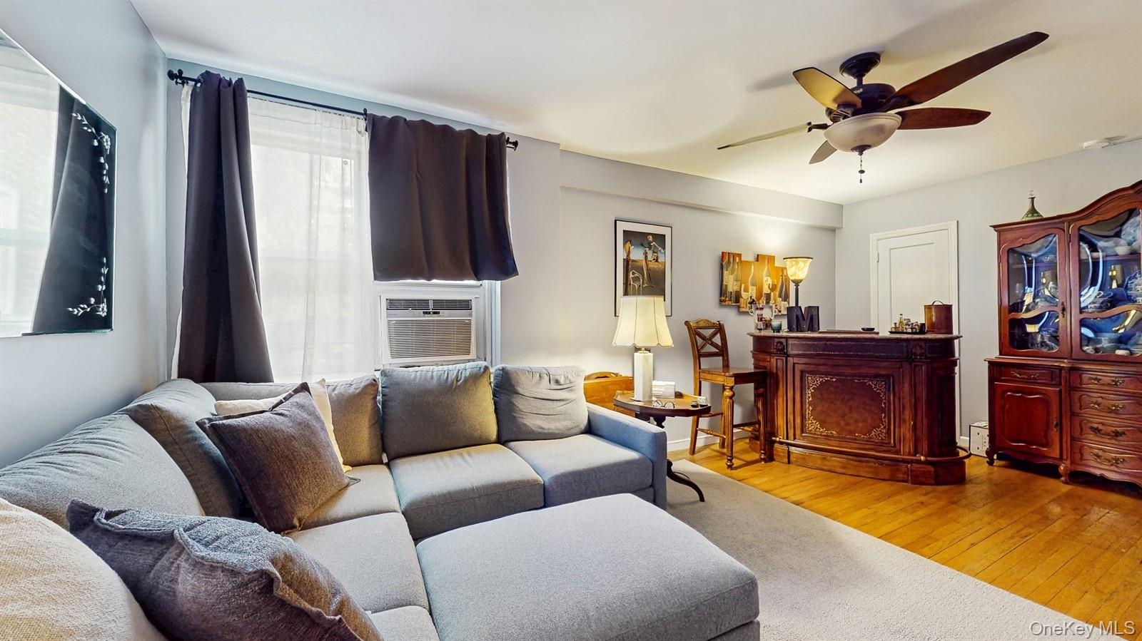 755 Bronx River Road, Unit 6C Bronxville, NY 10708 - Photo 5 of 22 Living room with hardwood / wood-style flooring, ceiling fan, and cooling unit