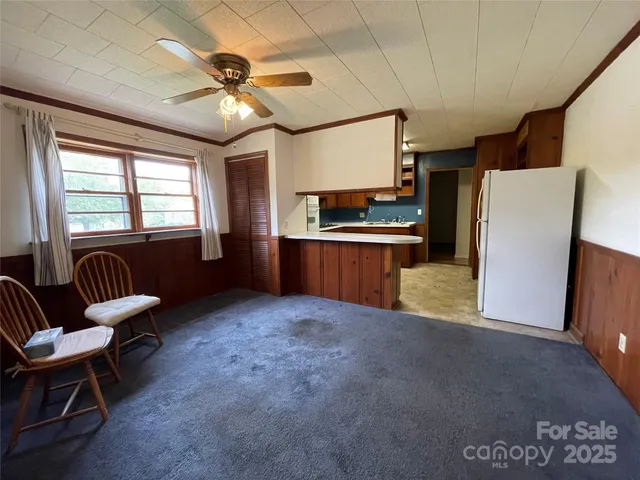 a view of kitchen with furniture and a refrigerator