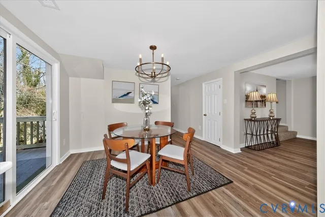 a dining room with furniture a rug and wooden floor