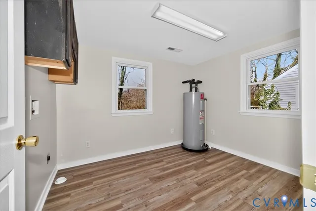 a view of an entryway with wooden floor