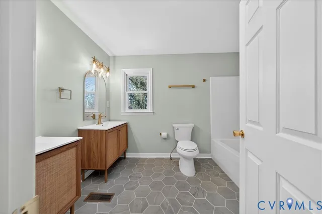 a bathroom with a toilet a sink and a mirror