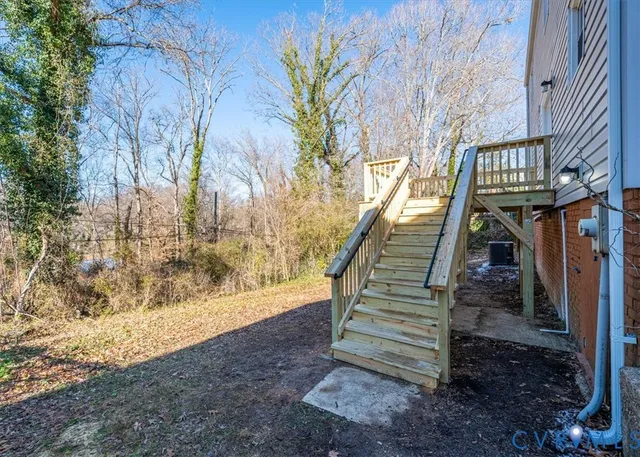 a view of a deck with a large window and wooden fence
