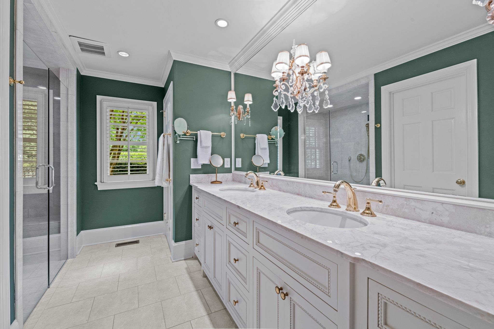 2217 St Marys Street Raleigh, NC 27608 - Photo 21 of 52 First Floor Owner's Suite bath features a frameless, curbless walk-in shower, marble countertops, Cifial french fixtures, and a water closet with bidet. Owner's Suite Bathroom