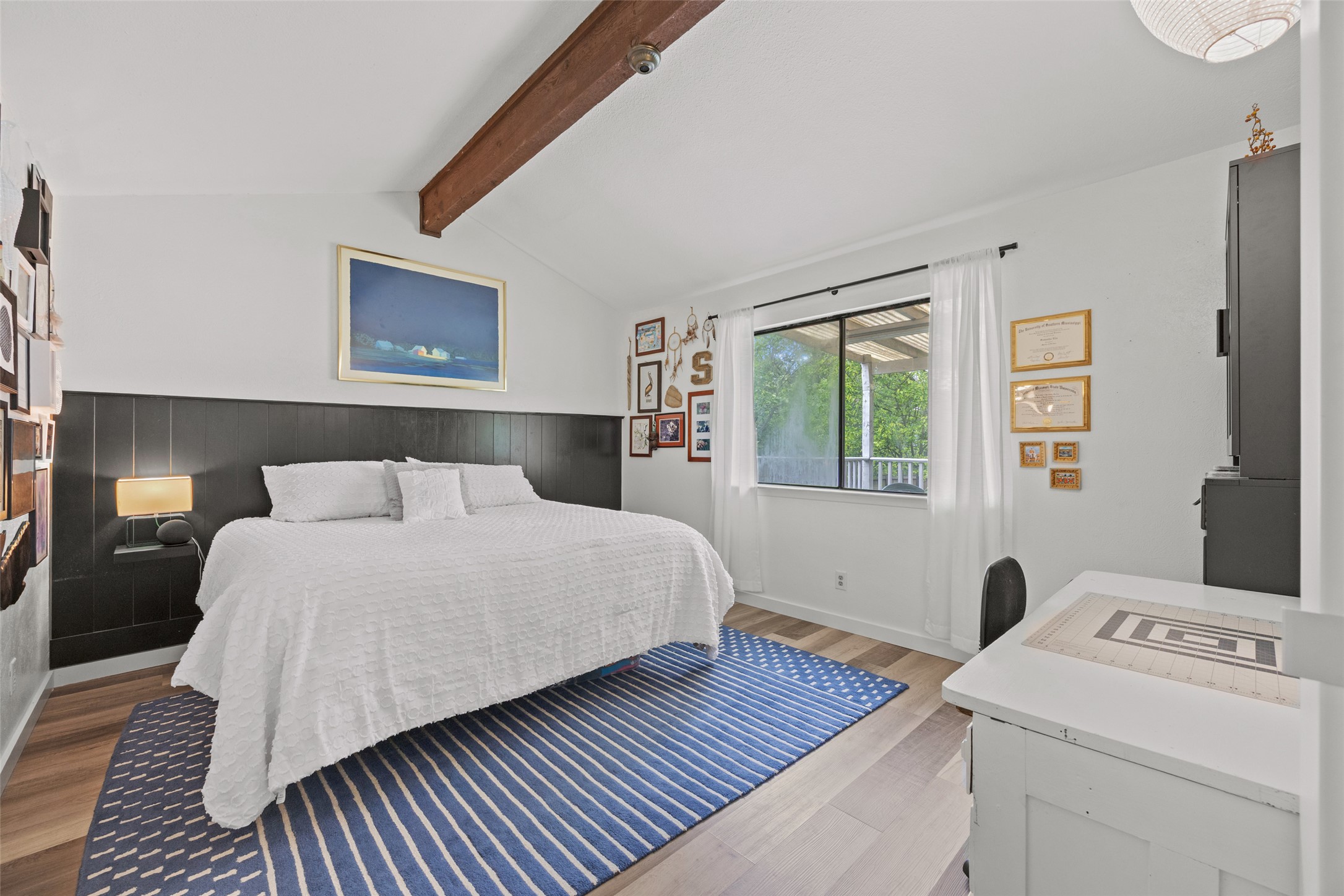 5506 South Pleasant Valley Road Austin, TX 78744 - Photo 19 of 25 A restful bedroom offers vaulted ceilings and a warm, inviting ambiance.