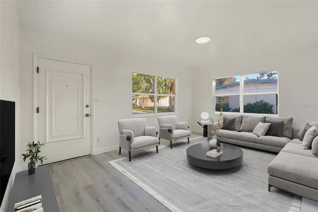 a living room with furniture and a large window