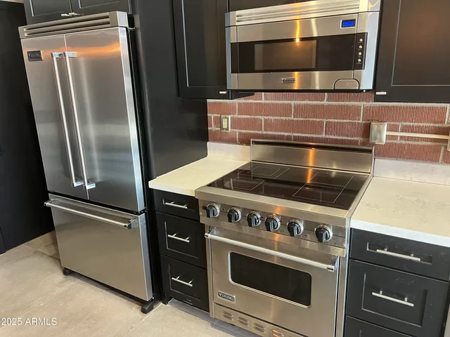 a stove top oven sitting inside of a kitchen