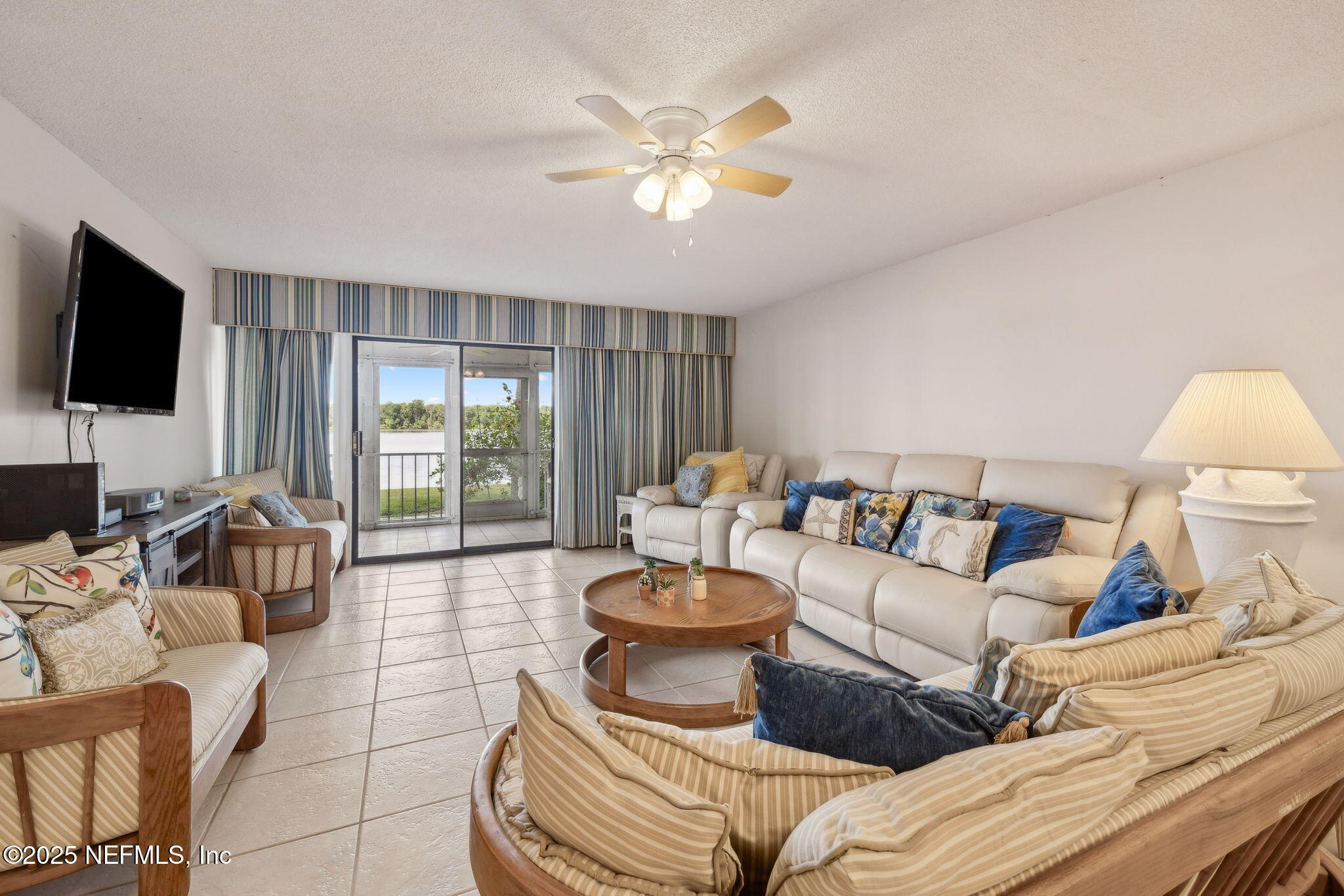 125 River Bend Road, Unit BLD D Welaka, FL 32193 - Photo 14 of 62 a living room with furniture and a flat screen tv