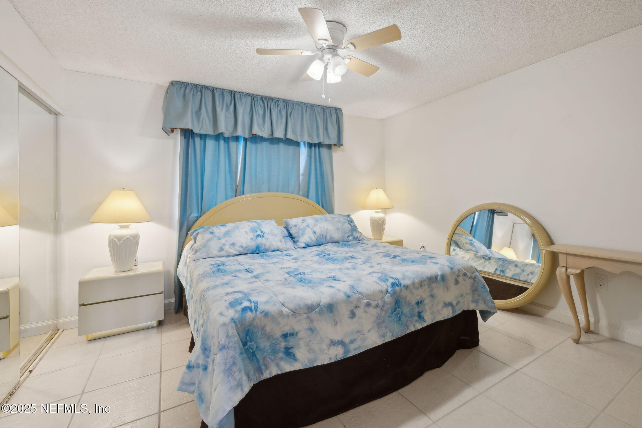 125 River Bend Road, Unit BLD D Welaka, FL 32193 - Photo 21 of 53 a bedroom with bed and a chandelier