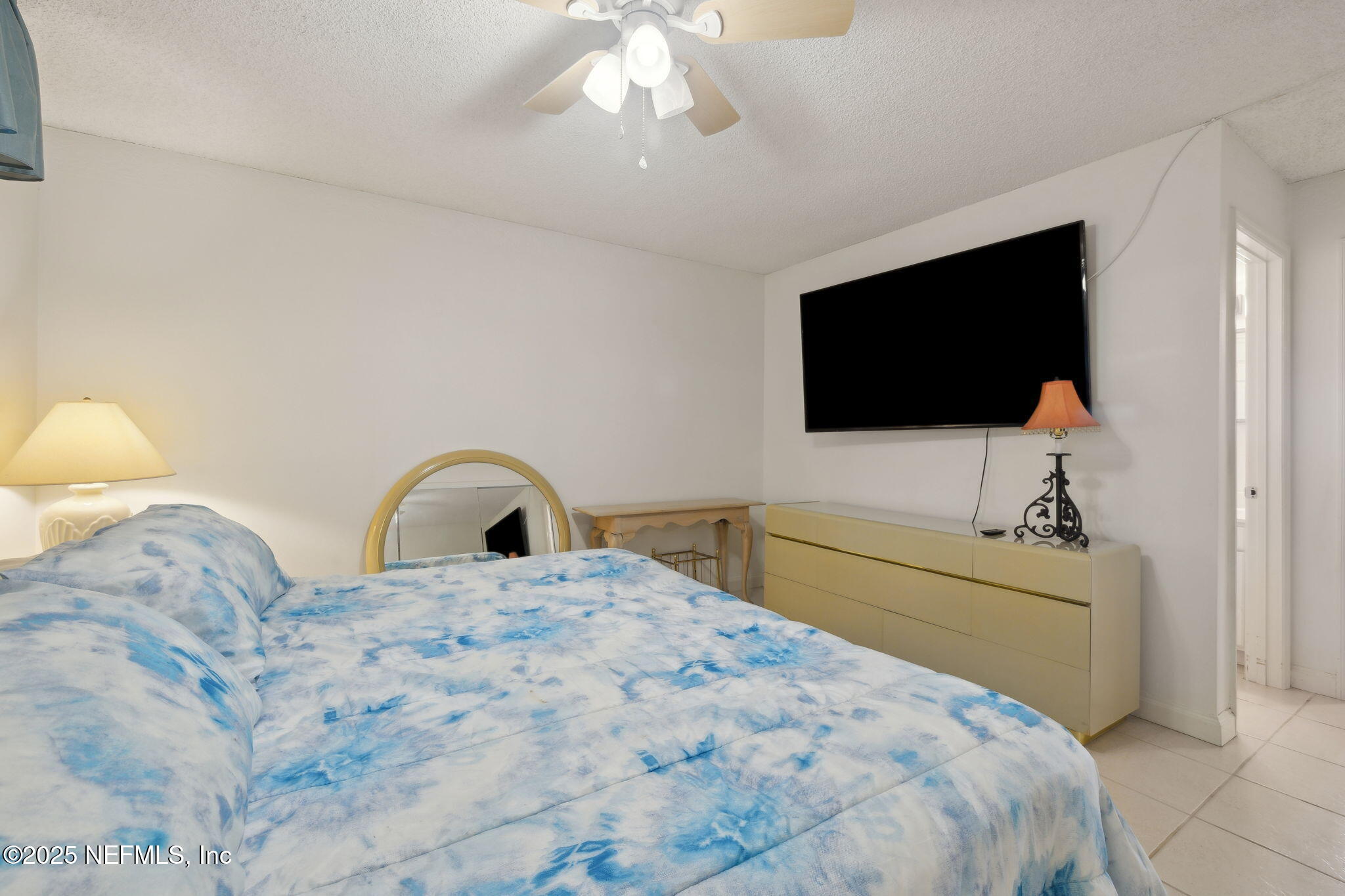 125 River Bend Road, Unit BLD D Welaka, FL 32193 - Photo 22 of 62 a bedroom with a bed and a flat screen tv