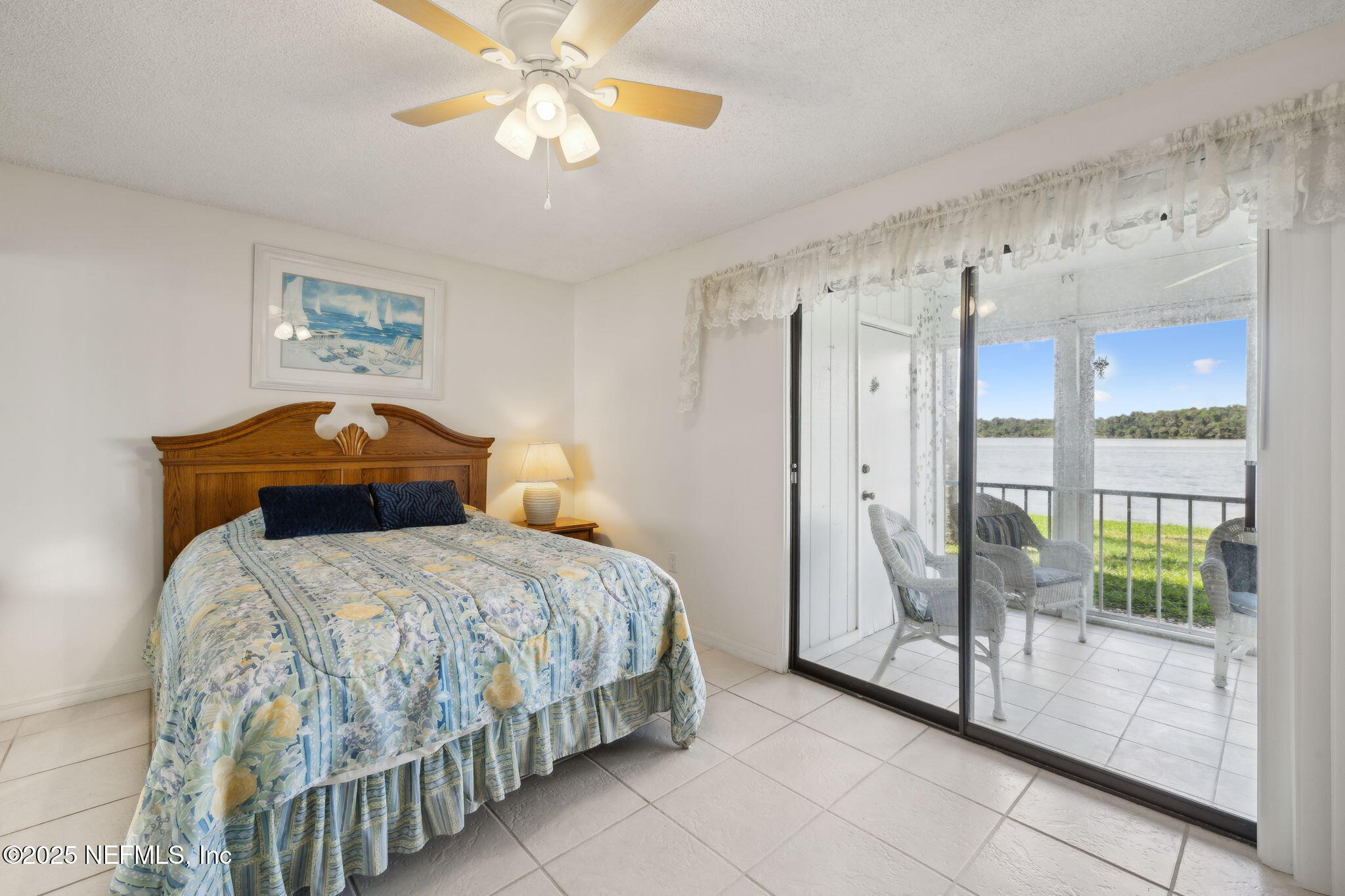 125 River Bend Road, Unit BLD D Welaka, FL 32193 - Photo 24 of 62 a bedroom with a bed and a chandelier