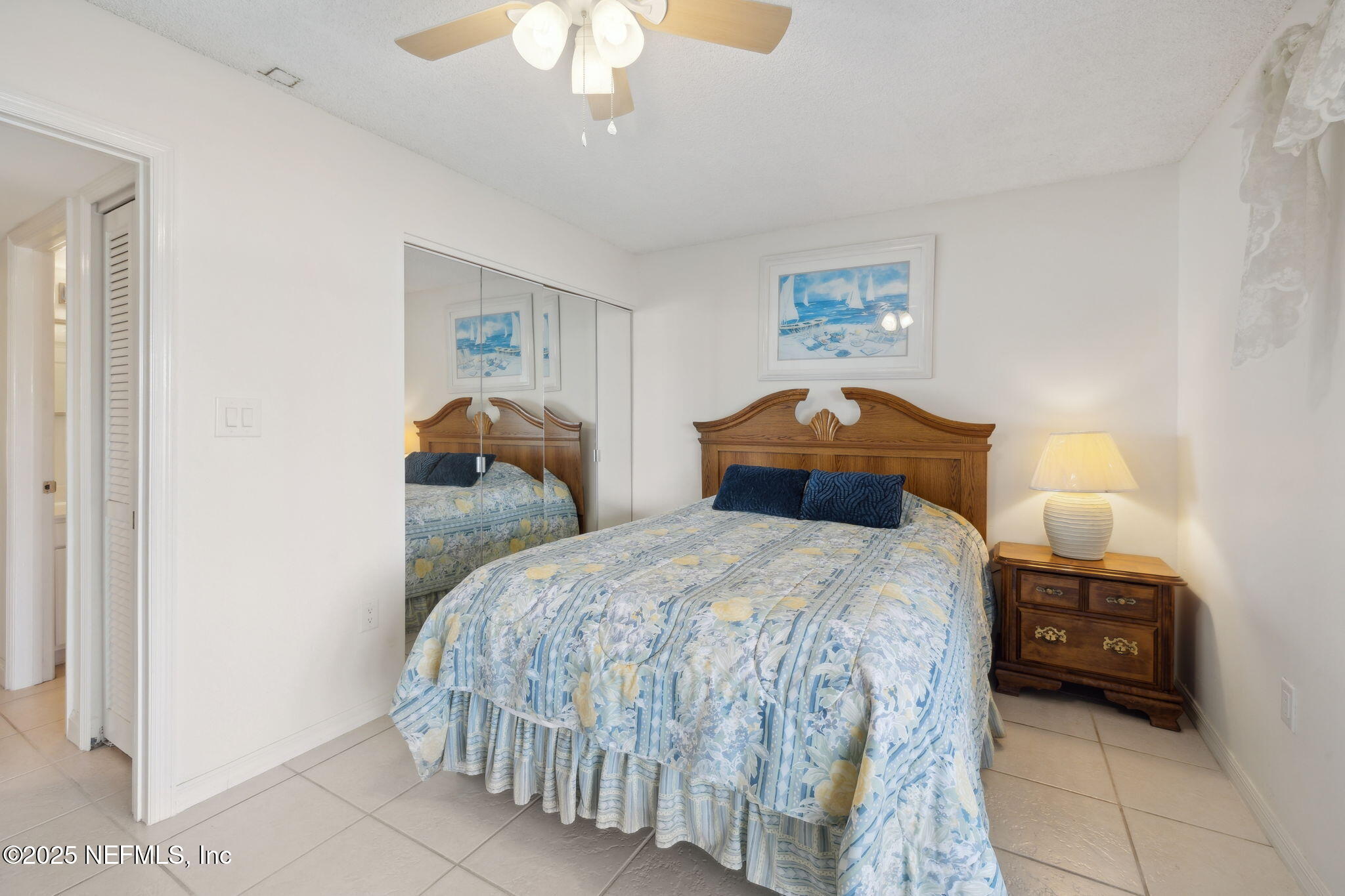 125 River Bend Road, Unit BLD D Welaka, FL 32193 - Photo 25 of 62 a bedroom with a bed and a chandelier
