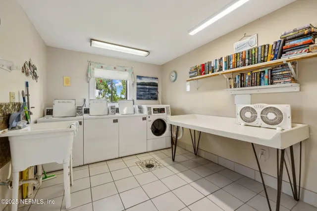 a view of a swimming pool with a lawn chairs and plants