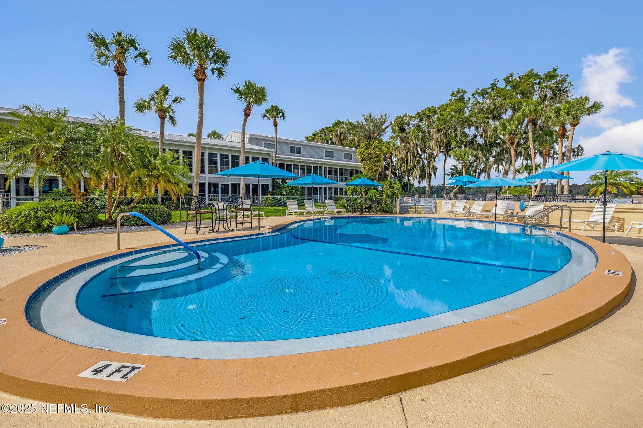 125 River Bend Road, Unit BLD D Welaka, FL 32193 - Photo 38 of 53 a view of a swimming pool with a lawn chairs and plants
