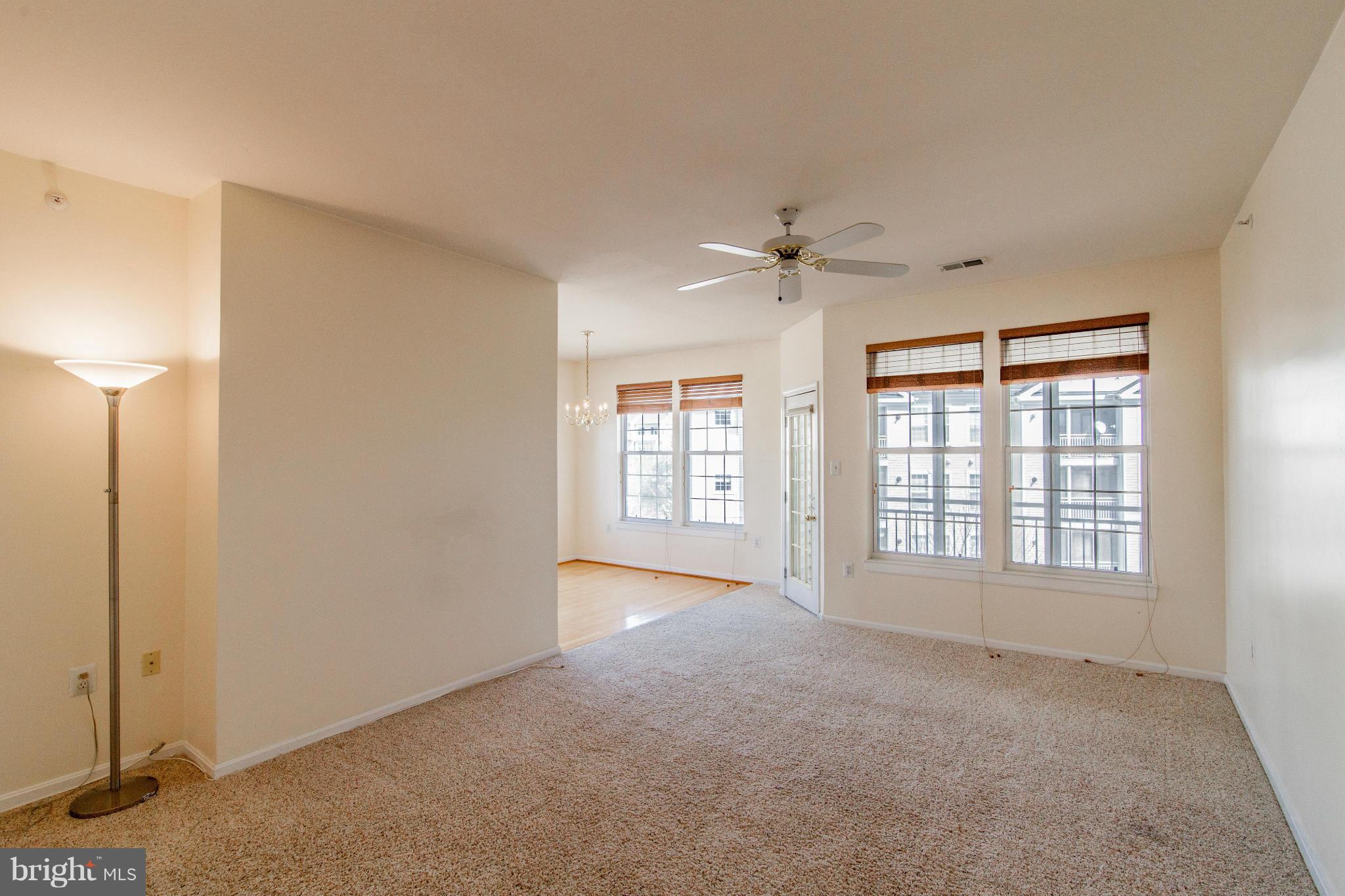 12008 Amber Ridge Circle, Unit A301 Germantown, MD 20876 - Photo 2 of 22 a view of an empty room with a window