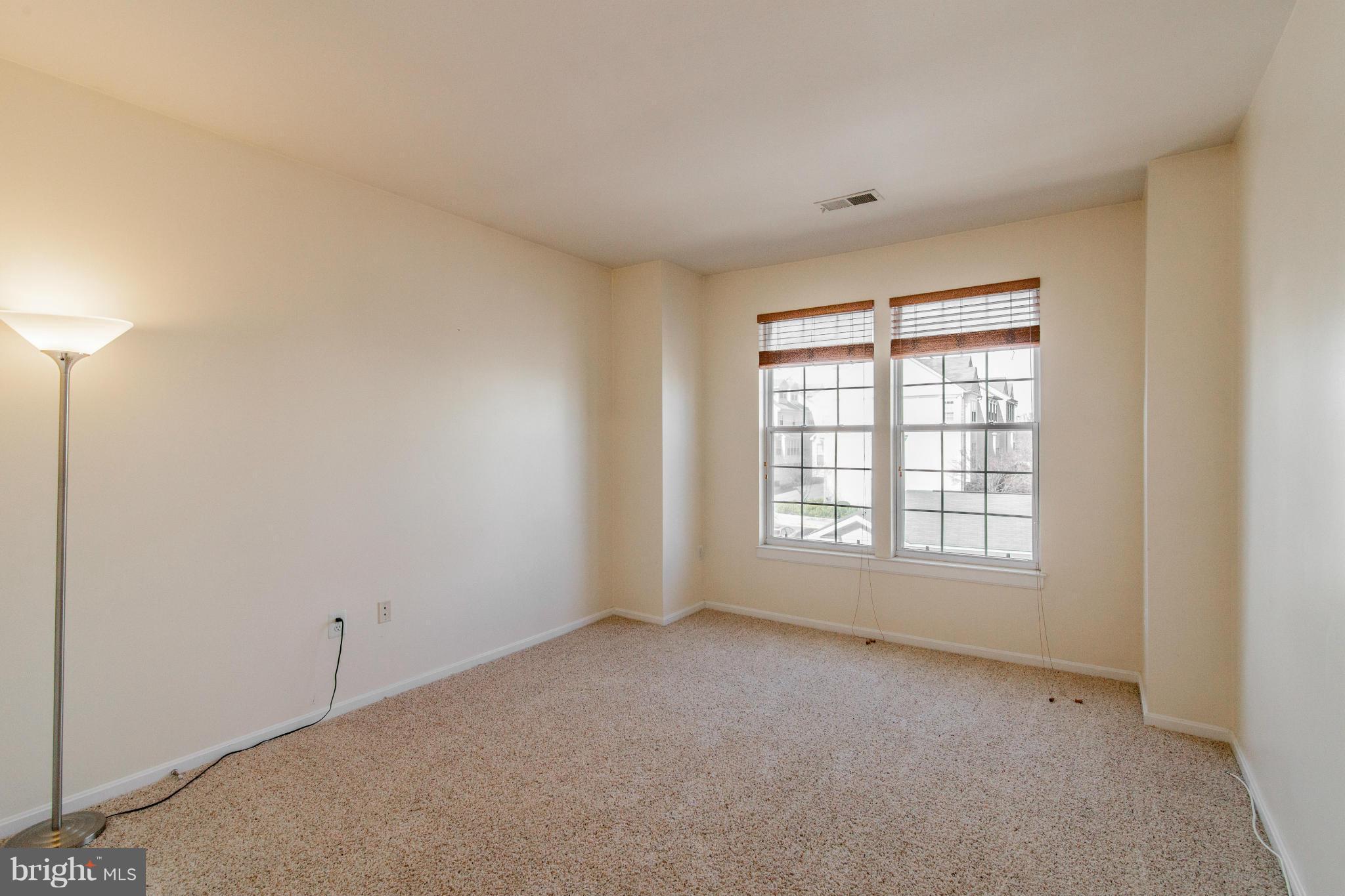 12008 Amber Ridge Circle, Unit A301 Germantown, MD 20876 - Photo 13 of 22 a view of an empty room with a window