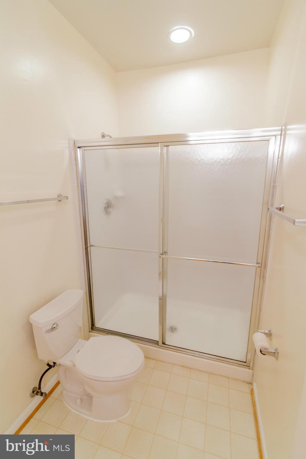 12008 Amber Ridge Circle, Unit A301 Germantown, MD 20876 - Photo 16 of 22 a bathroom with a toilet and a shower
