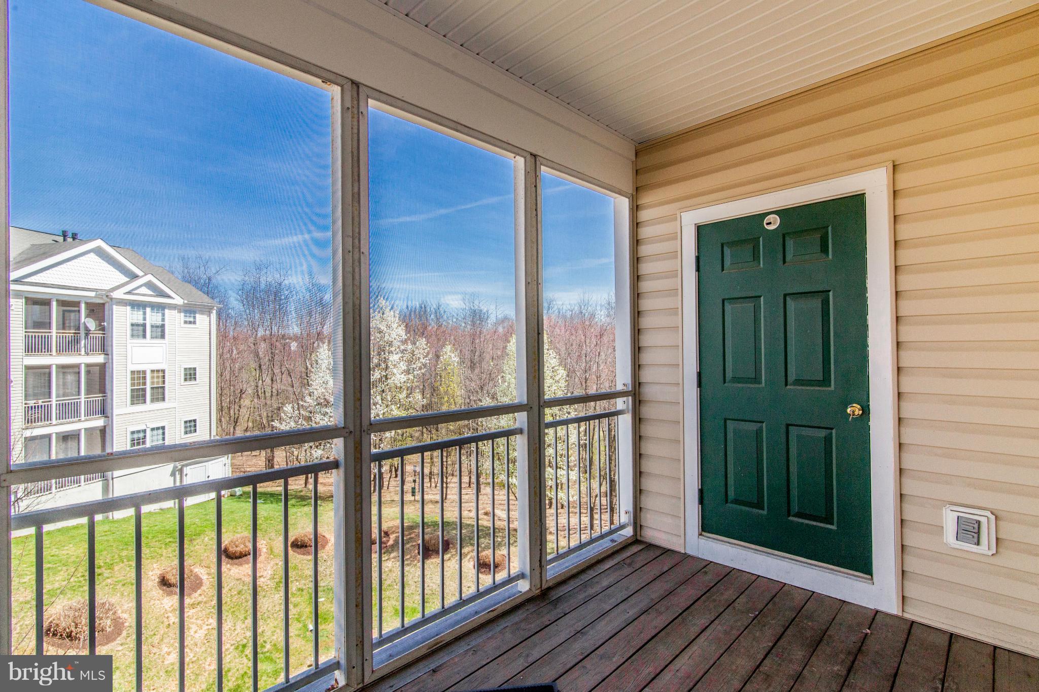 12008 Amber Ridge Circle, Unit A301 Germantown, MD 20876 - Photo 19 of 22 a view of a balcony with wooden floor