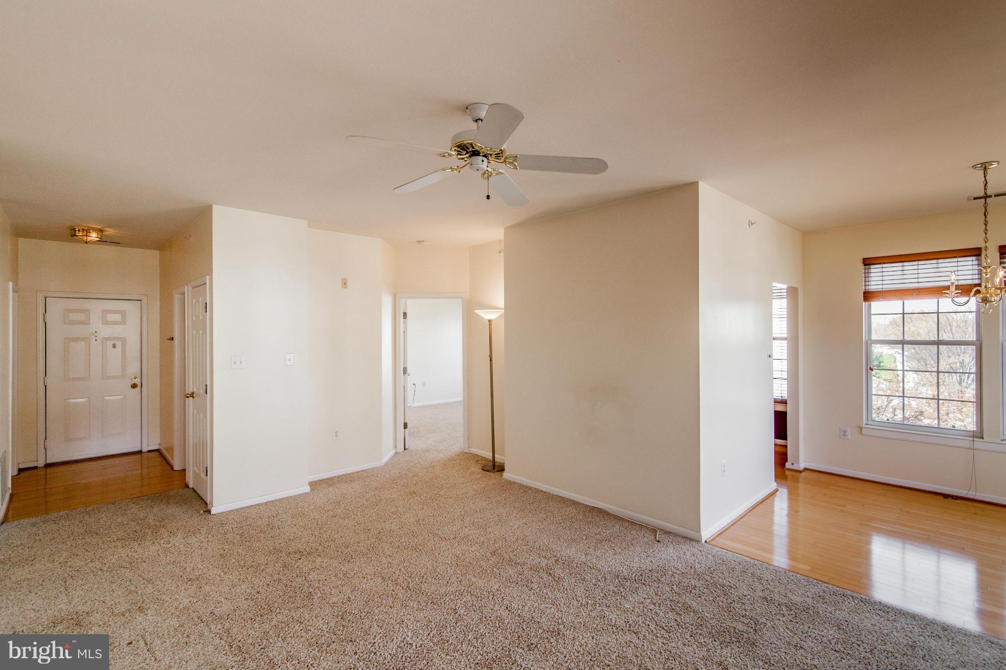 12008 Amber Ridge Circle, Unit A301 Germantown, MD 20876 - Photo 3 of 22 a view of an empty room with a window and a kitchen
